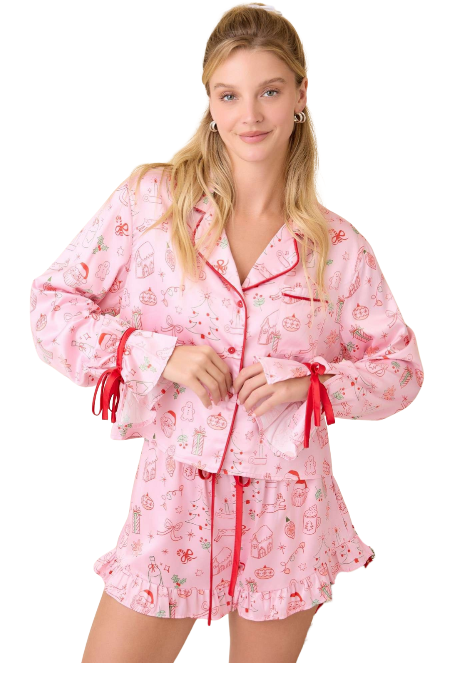 Woman wearing a pink floral pajama set with red accents on a white background
